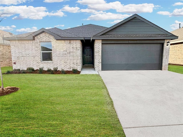 ranch-style home featuring a front yard, concrete driveway, brick siding, and an attached garage