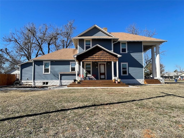 front of property featuring a front lawn and covered porch