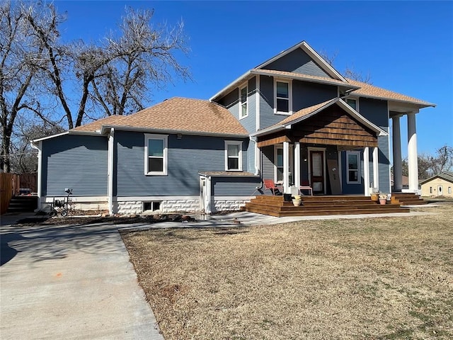 view of front of property with covered porch and a front yard