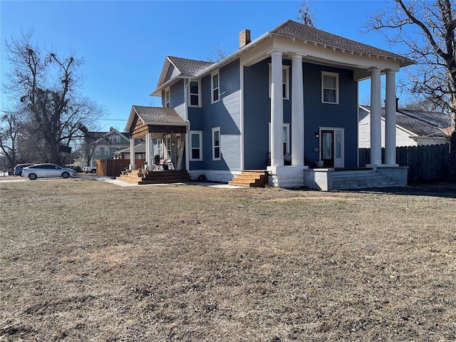 exterior space with covered porch and a lawn