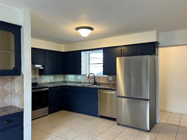 kitchen featuring stainless steel appliances, light tile patterned flooring, sink, and backsplash