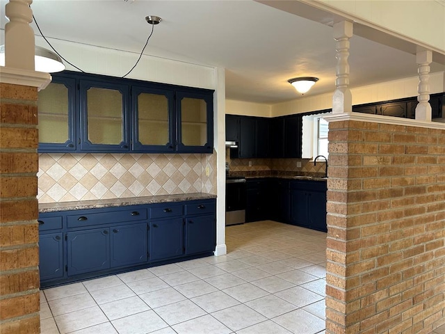 kitchen with light tile patterned flooring, sink, stainless steel range with electric cooktop, decorative backsplash, and blue cabinetry