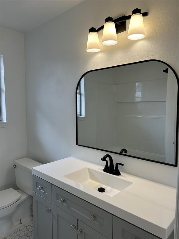 bathroom featuring vanity and toilet