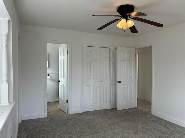 unfurnished bedroom featuring ceiling fan, ensuite bath, a closet, and light carpet