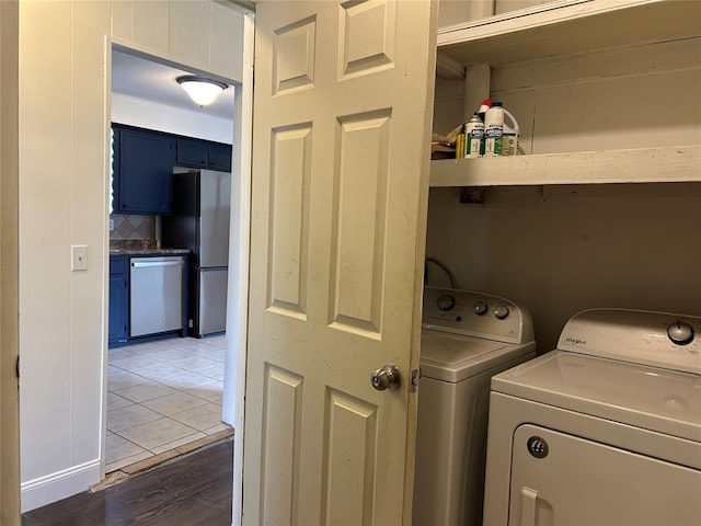 washroom featuring dark hardwood / wood-style flooring and washer and clothes dryer