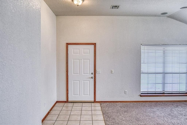 10700 NW 36th Pl, Yukon, OK 73099 - unfurnished room with light tile patterned floors, a textured wall, baseboards, and a textured ceiling