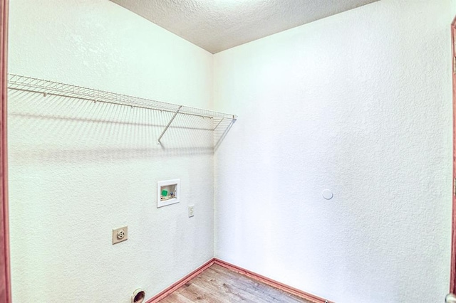10700 NW 36th Pl, Yukon, OK 73099 - clothes washing area featuring electric dryer hookup, light wood-style floors, washer hookup, a textured ceiling, and a textured wall