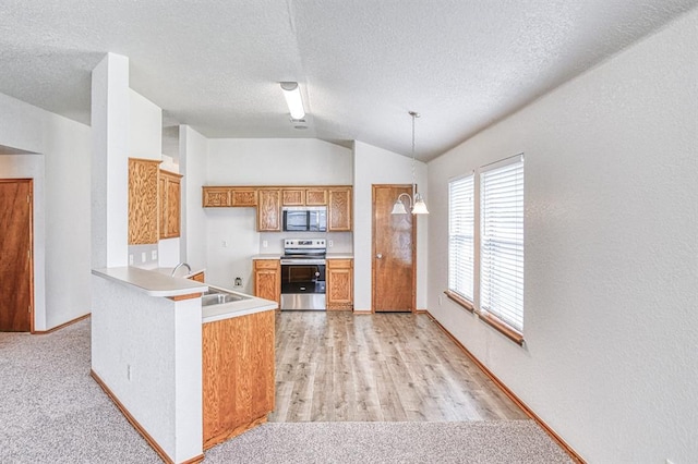10700 NW 36th Pl, Yukon, OK 73099 - kitchen featuring stainless steel appliances, a sink, lofted ceiling, brown cabinets, and light countertops