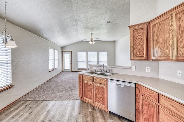 10700 NW 36th Pl, Yukon, OK 73099 - kitchen with dishwasher, a sink, lofted ceiling, a textured ceiling, and open floor plan