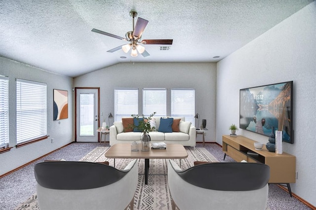10700 NW 36th Pl, Yukon, OK 73099 - carpeted living room with lofted ceiling, plenty of natural light, ceiling fan, baseboards, and a textured ceiling