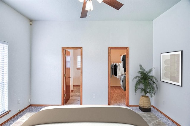 10700 NW 36th Pl, Yukon, OK 73099 - unfurnished bedroom with multiple windows, a spacious closet, carpet floors, and baseboards