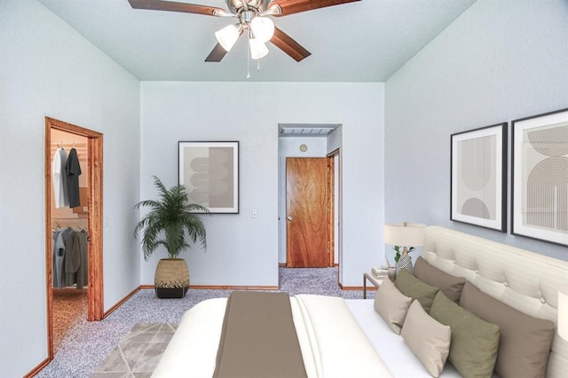10700 NW 36th Pl, Yukon, OK 73099 - bedroom with a walk in closet, carpet flooring, baseboards, a closet, and a ceiling fan