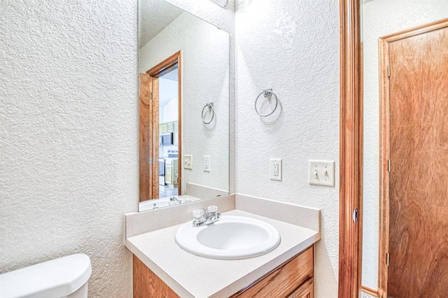 10700 NW 36th Pl, Yukon, OK 73099 - half bath with a textured wall, toilet, and vanity