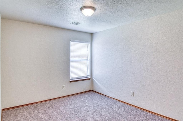 10700 NW 36th Pl, Yukon, OK 73099 - carpeted spare room featuring a textured ceiling and a textured wall