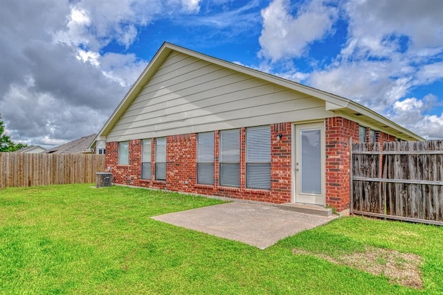10700 NW 36th Pl, Yukon, OK 73099 - rear view of property with brick siding and a patio
