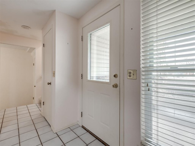 entryway with light tile patterned flooring