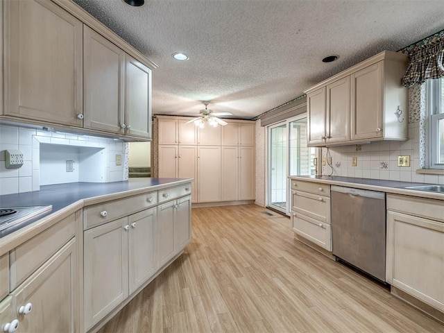 kitchen featuring ceiling fan, a healthy amount of sunlight, stainless steel dishwasher, and light hardwood / wood-style floors