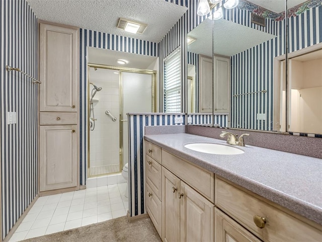 bathroom featuring vanity, a textured ceiling, and walk in shower