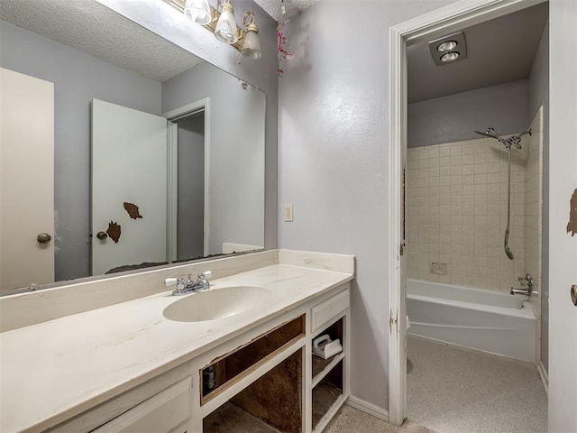 bathroom with vanity, tiled shower / bath combo, and a textured ceiling