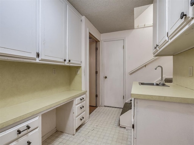 laundry room featuring sink and a textured ceiling