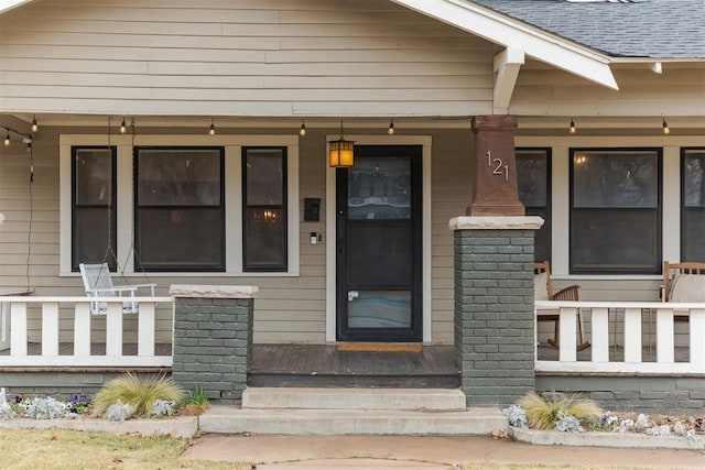 doorway to property featuring covered porch