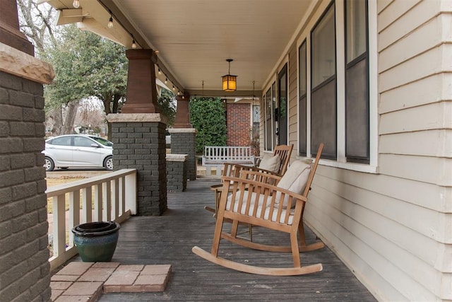 wooden terrace with a porch