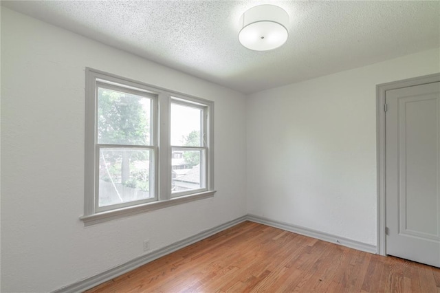 3125 NW 24th St, Oklahoma City, OK 73107 - spare room with a textured ceiling, light wood finished floors, and baseboards