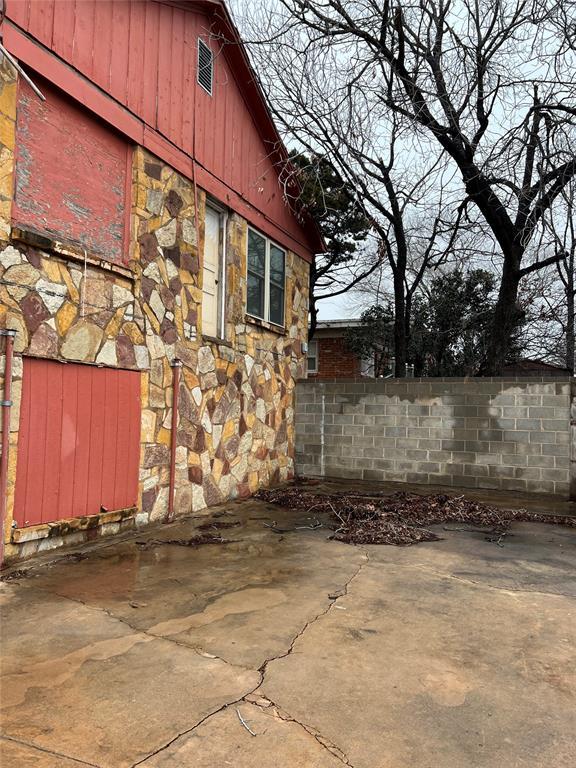 view of side of property with a patio