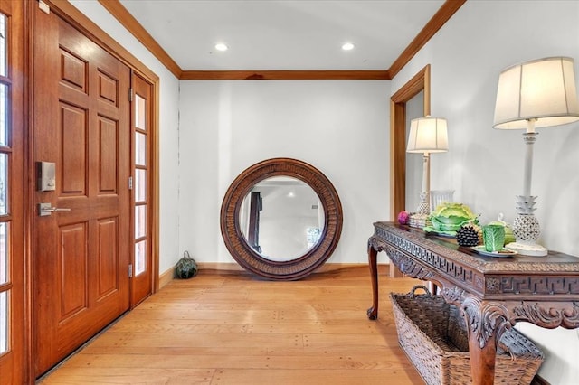 foyer with baseboards, ornamental molding, light wood-style flooring, and recessed lighting