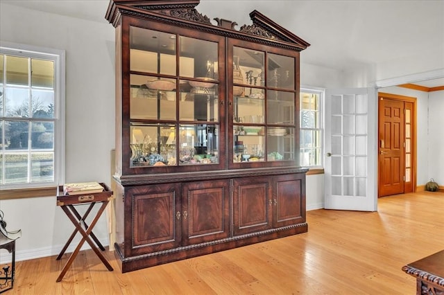 interior space featuring baseboards and wood finished floors