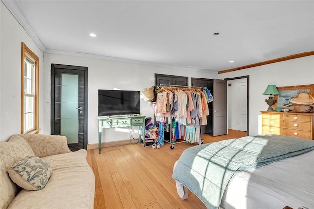 bedroom featuring ornamental molding, recessed lighting, light wood-style flooring, and baseboards