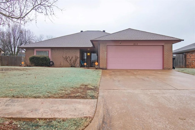 view of front facade with brick siding, driveway, and an attached garage