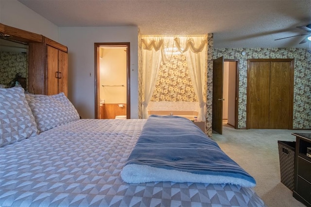 bedroom featuring a textured ceiling, carpet floors, ceiling fan, and wallpapered walls