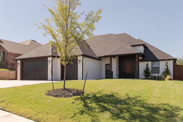 view of front of house with a garage and a front yard