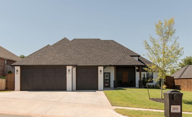 view of front of property with a garage and a front yard