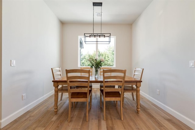 dining space with light hardwood / wood-style floors