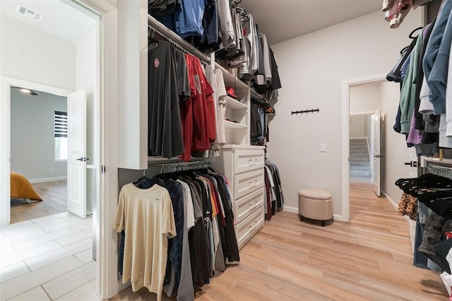 spacious closet with light hardwood / wood-style flooring