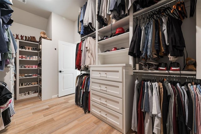 walk in closet featuring light hardwood / wood-style flooring