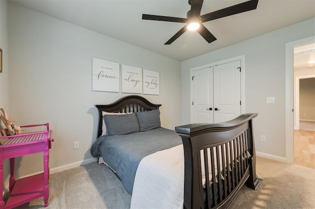 bedroom featuring light carpet, a closet, and ceiling fan