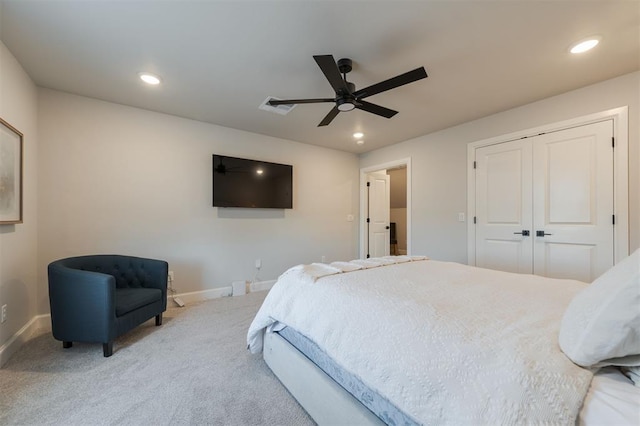 carpeted bedroom with ceiling fan and a closet