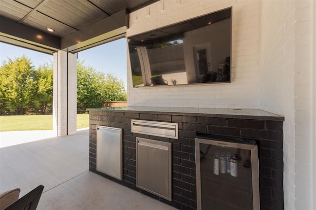 view of patio with wine cooler and an outdoor kitchen