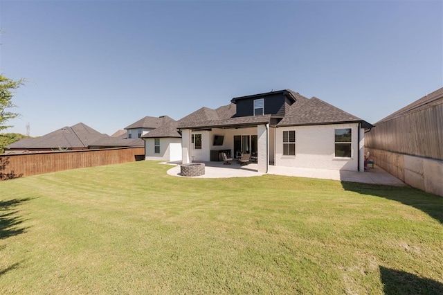 rear view of property featuring a patio and a lawn