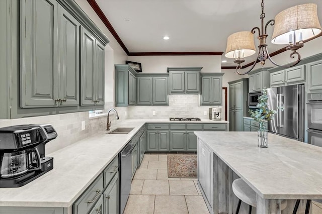 kitchen with sink, crown molding, appliances with stainless steel finishes, pendant lighting, and decorative backsplash