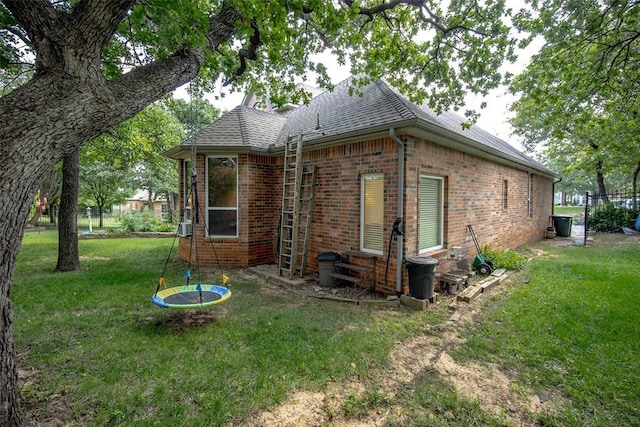 rear view of house featuring a lawn