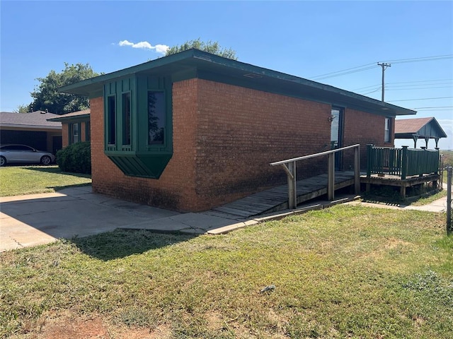 view of side of property featuring a wooden deck and a lawn