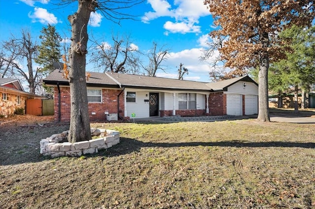 ranch-style house with an attached garage, a front lawn, and brick siding