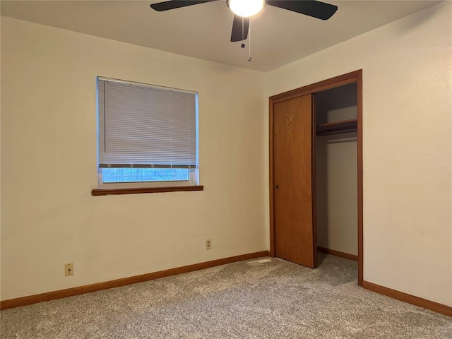 unfurnished bedroom with a closet, ceiling fan, and light colored carpet