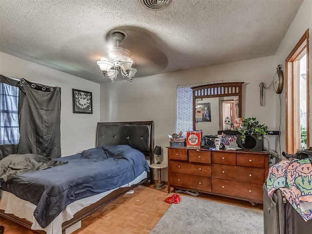 bedroom featuring light parquet flooring and a textured ceiling