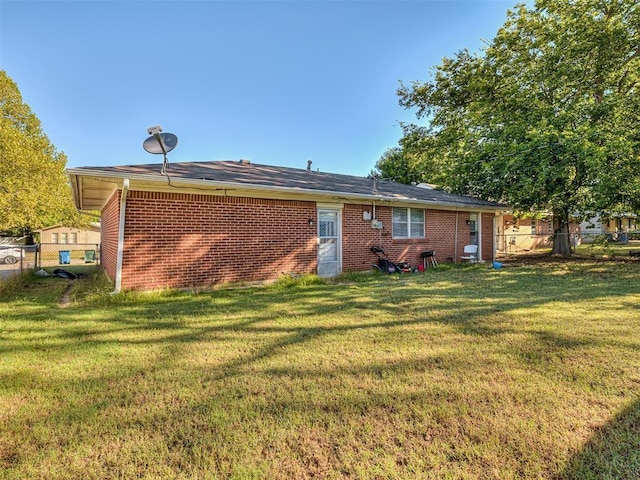 rear view of house featuring a yard