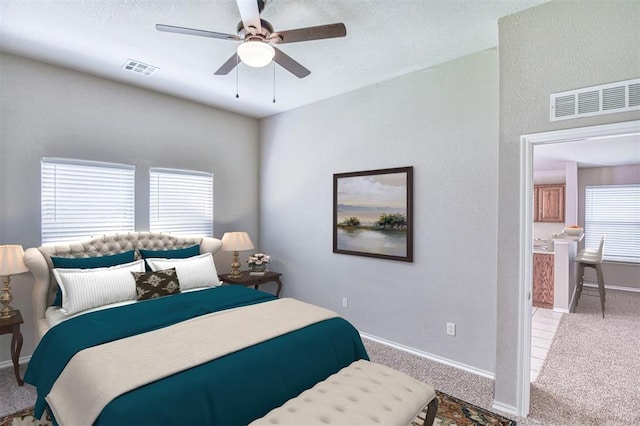 carpeted bedroom with baseboards and a ceiling fan